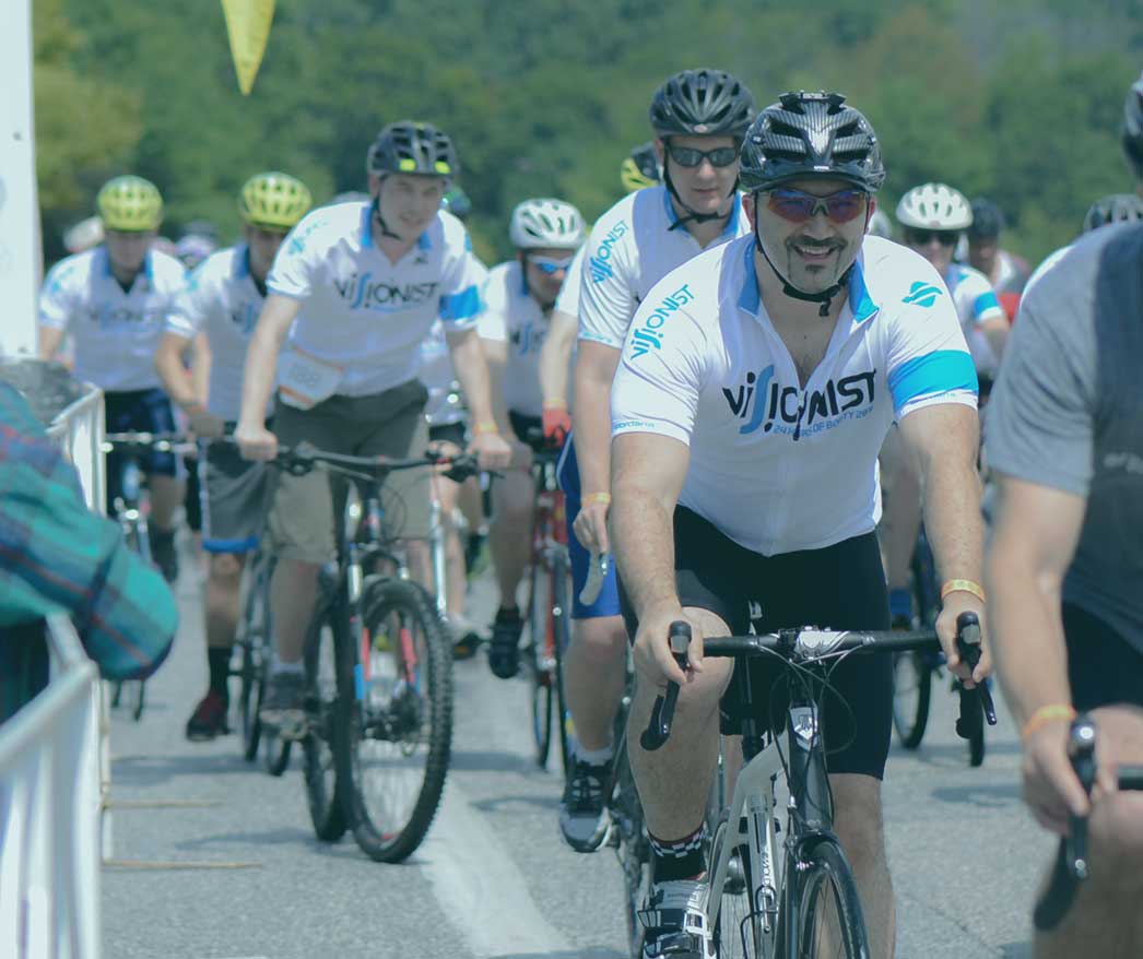 Visionist employees riding bikes in team jerseys